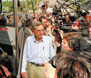 Physicist Dr. Richard Kinder is mobbed by paparazzi outside his University of Chicago office.